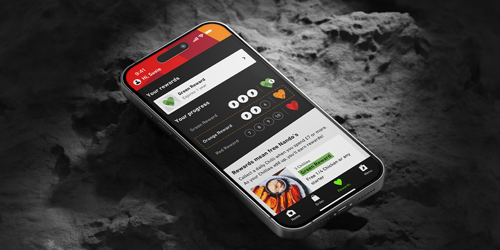 The image shows a picture of a phone with a nando's loyalty app.